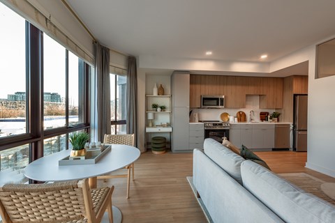 A modern living room with a dining table and chairs.