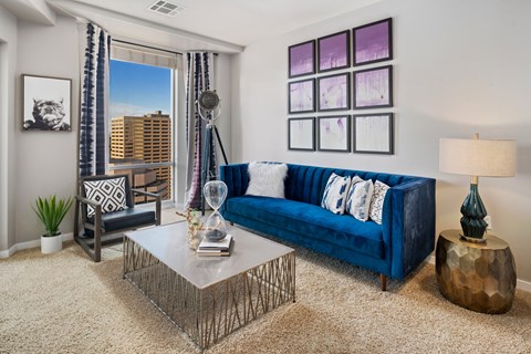 A living room with a blue couch and a coffee table.