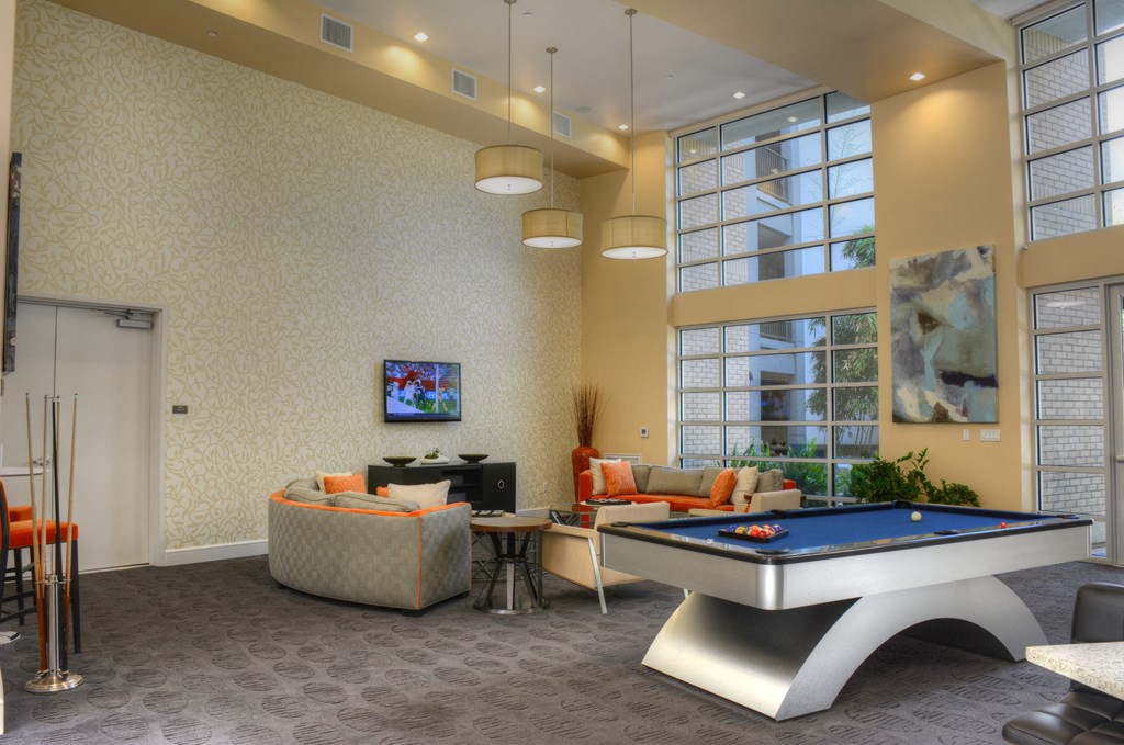 Resident lounge with wall tv, billiard and seating area