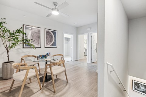 a dining room with a glass table and chairs