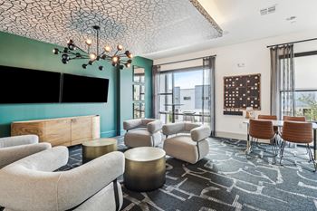 Two-level social clubhouse with game lounge, TV room, kitchen, work-well space with reservable private offices, and conference room