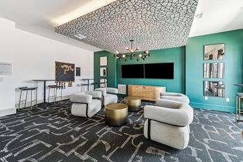 a living room with couches and chairs and a tv