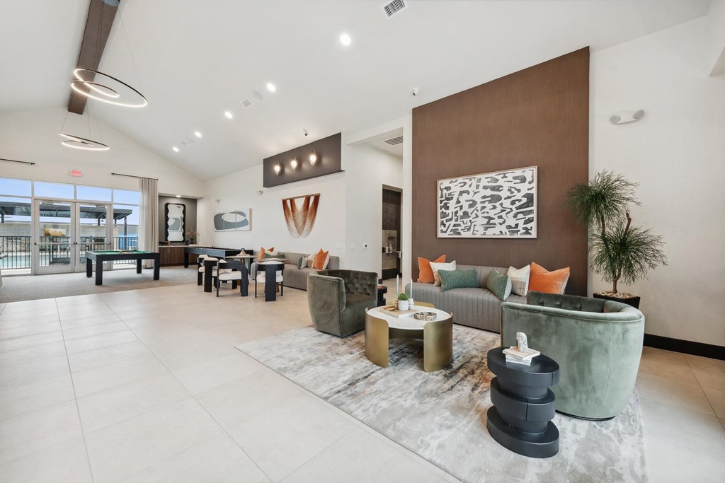 A modern living room with a large rug and a green sofa.