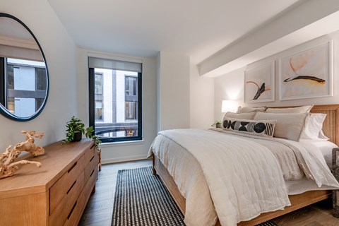 a bedroom with a bed and a dresser