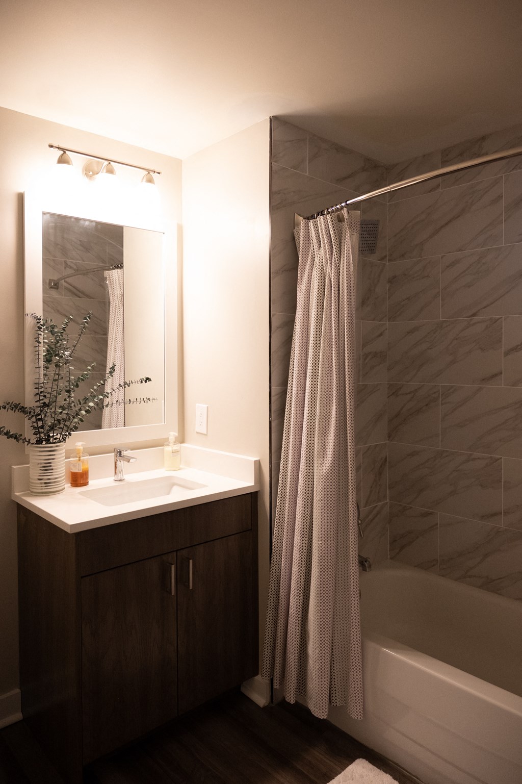 a bathroom with a sink and a bathtub in a 555 waverly unit