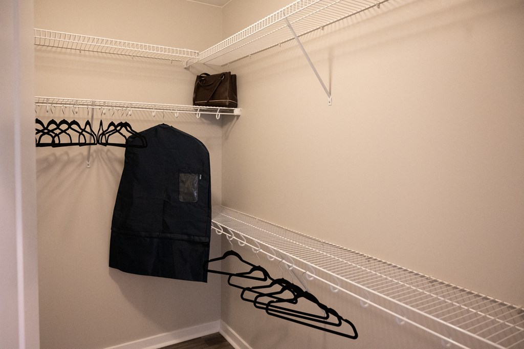 a coat rack in a walk in closet