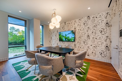 conference room with a table and chairs and a tv on the wall