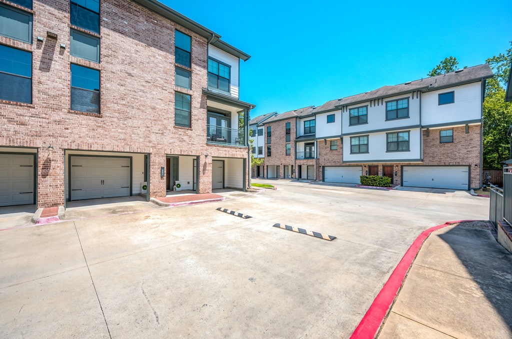 an empty parking lot in front of a brick building
