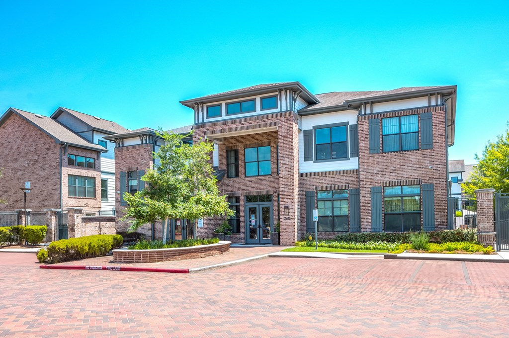 a large brick building with a tree in front of it