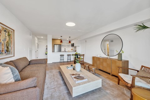 A living room with a brown couch and a coffee table in the center.