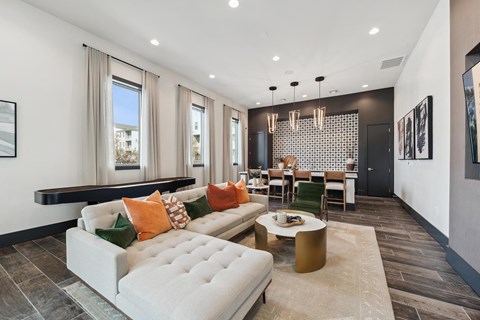 A modern living room with a white sofa and a coffee table.