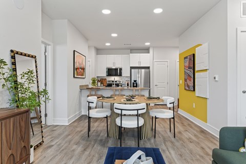 A modern kitchen with a dining table and chairs.
