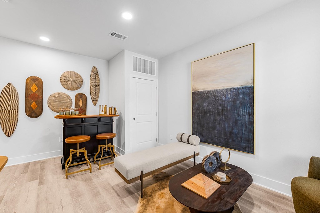 A living room with a dark brown coffee table and a white sofa.