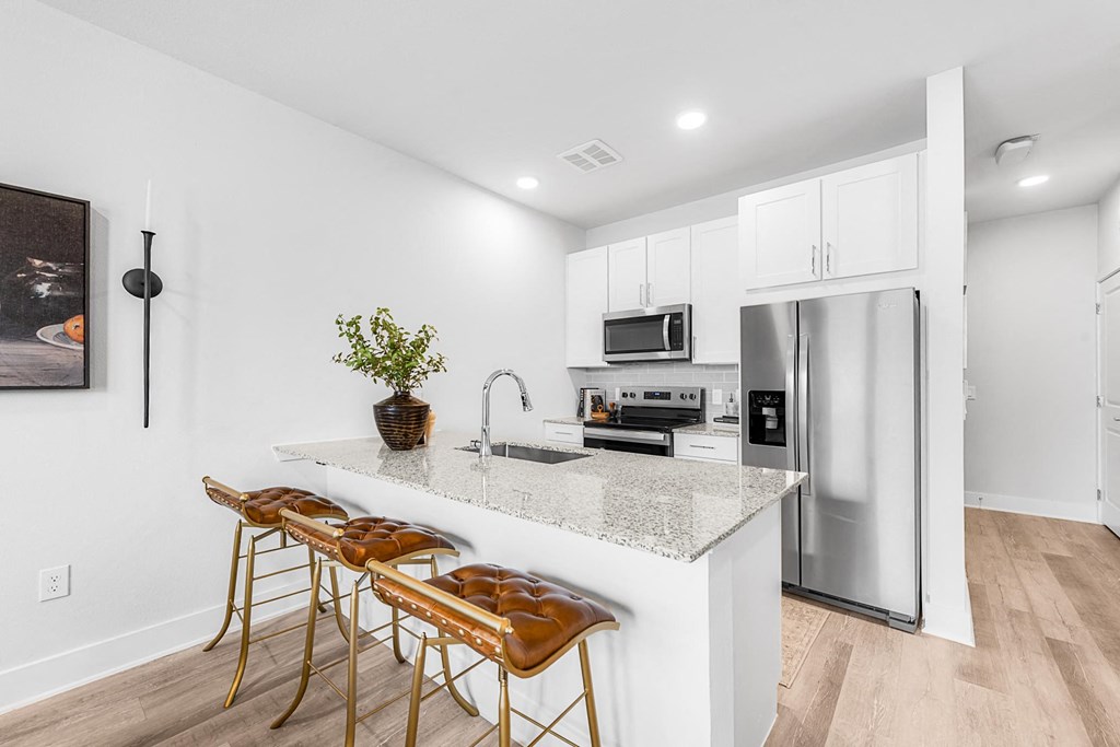 A kitchen with a white countertop and a refrigerator.