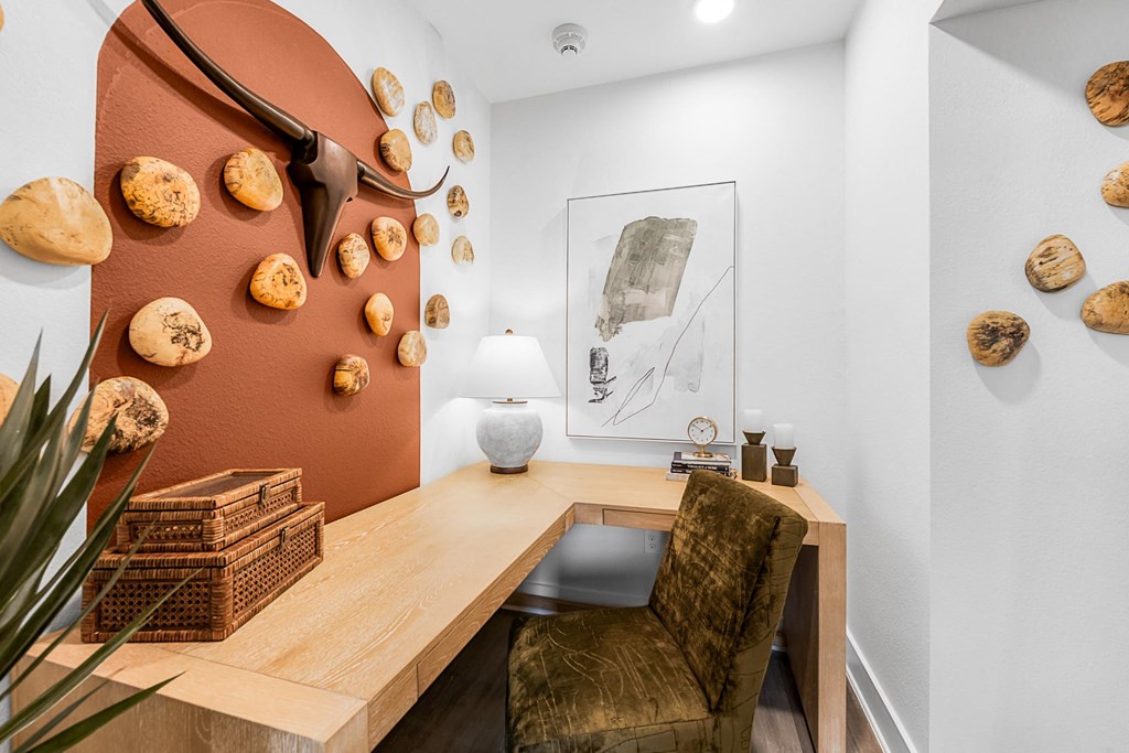 A brown desk with a chair and a wall with shells on it.
