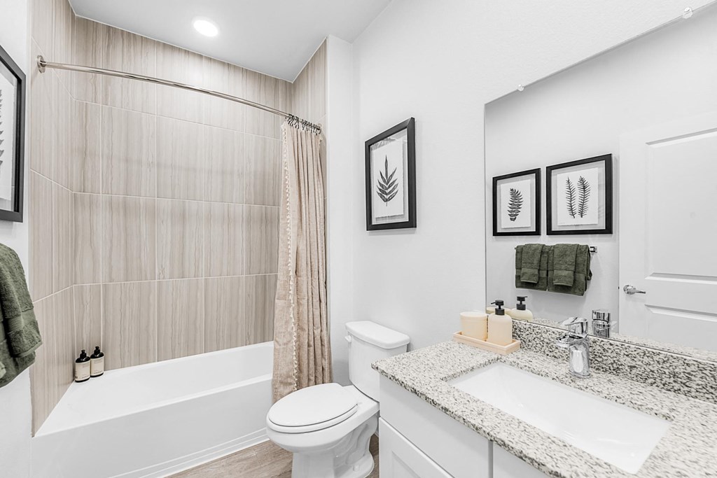 A bathroom with a white toilet, a white sink, and a white bathtub.