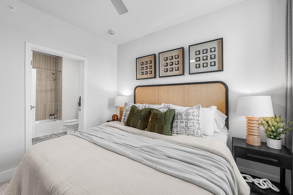 A bedroom with a large bed and a wooden headboard.