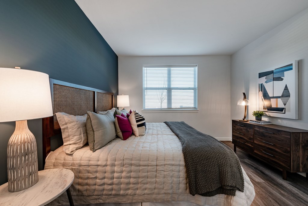 A bedroom with a bed, nightstand, and a painting on the wall. at Brandywine Green, Brandywine