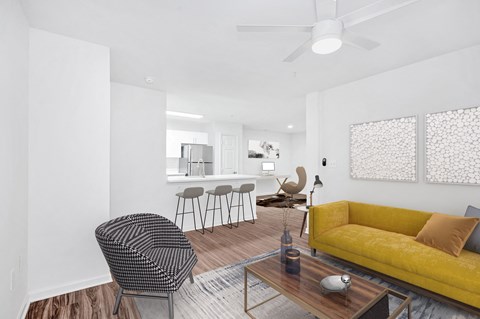 a living room with a yellow couch and a table with chairs