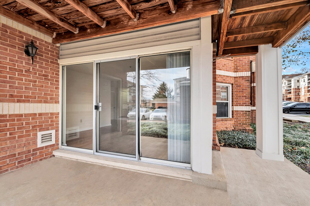 the view of a brick house with sliding glass doors