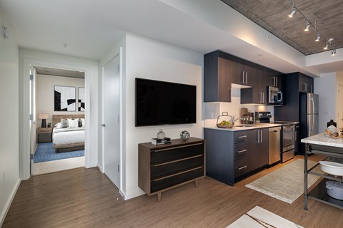 A modern kitchen with dark wood cabinets and a white countertop.