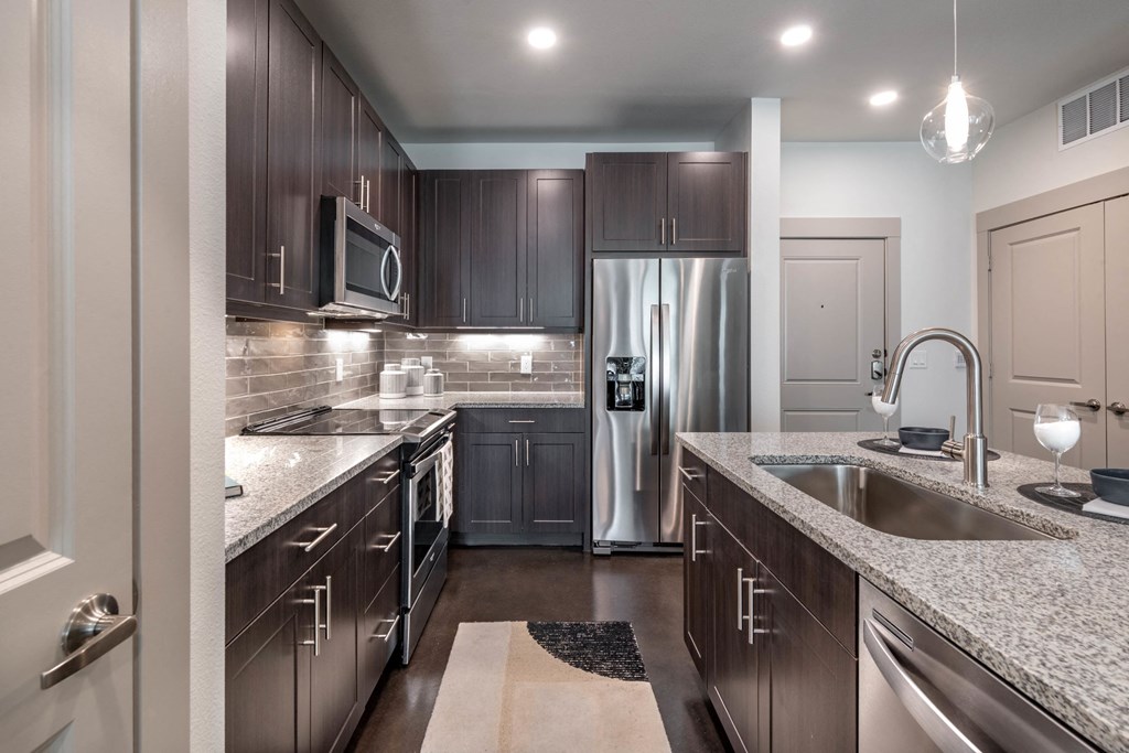 a kitchen with stainless steel appliances and granite counter tops