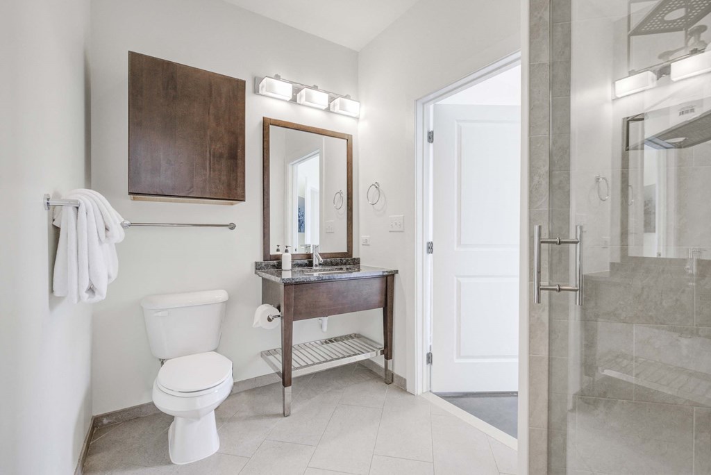 a bathroom with a toilet and a sink and a shower