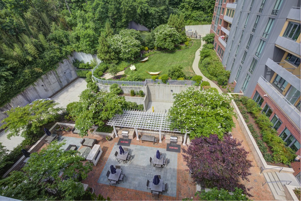 an aerial view of a courtyard with trees and a table and chairs