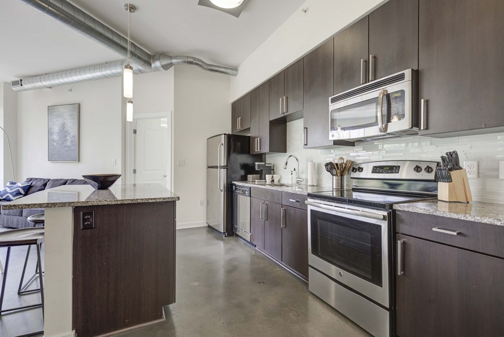 a kitchen with stainless steel appliances and wooden cabinets