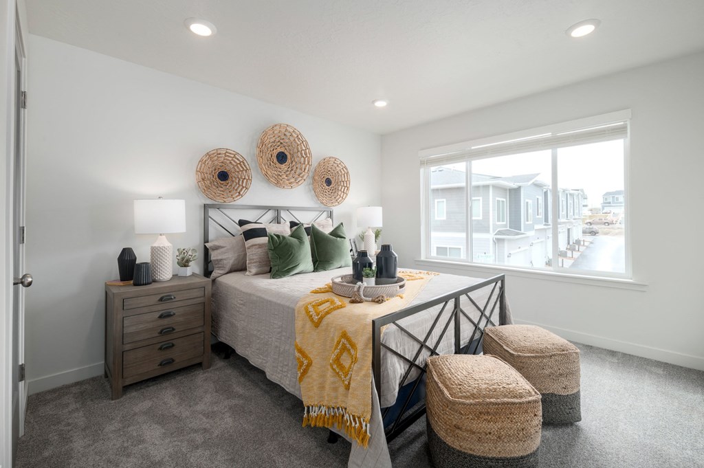 the master bedroom in a new home with a bed and a window