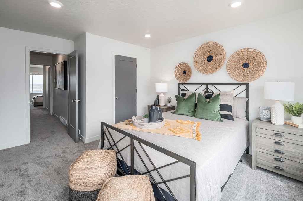 a bedroom with a bed and three baskets on the wall