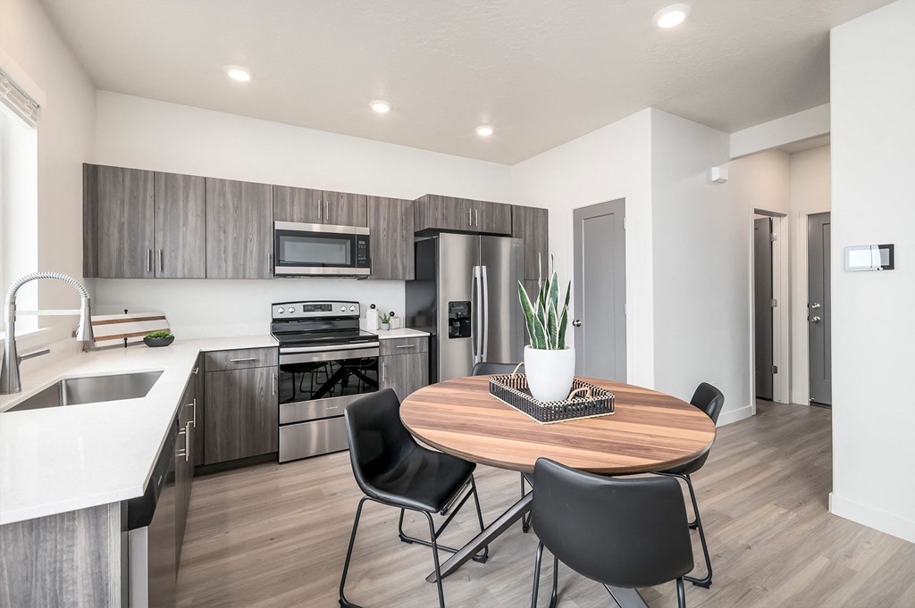 a kitchen and dining room with a table and chairs