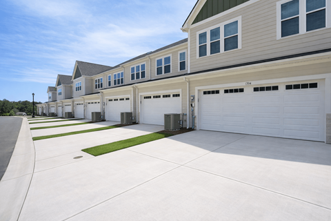 A row of houses with garages in front.
