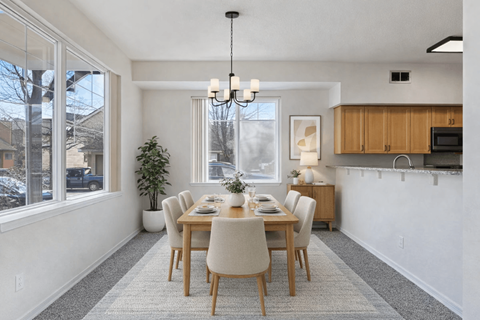 A dining room with a table set for six.