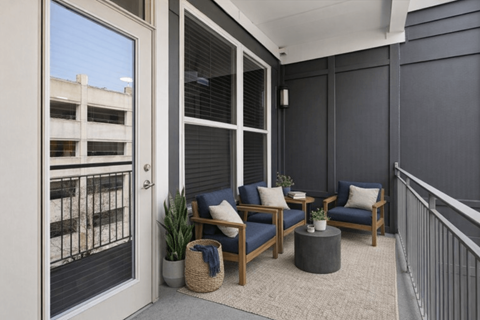 A balcony with a table and chairs is shown.