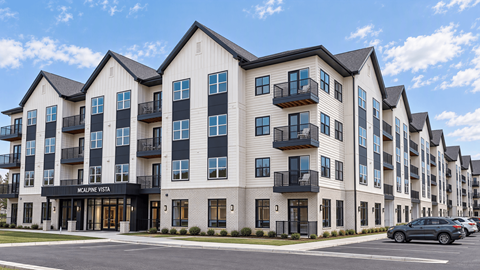 A row of white apartment buildings with balconies and the name "McAlpine Vista" on the front.