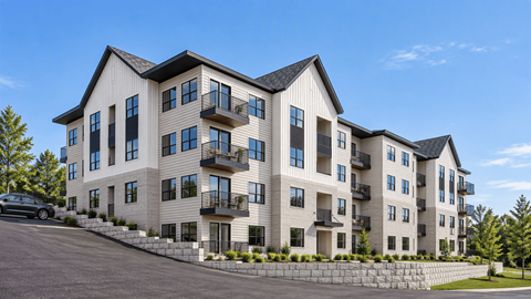 A large, modern apartment building with balconies and multiple windows.