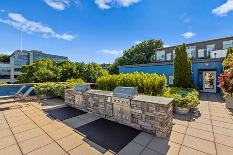 a fire pit on the roof of a building with a blue sky in the background  at Dexter Lake Union, Seattle, WA