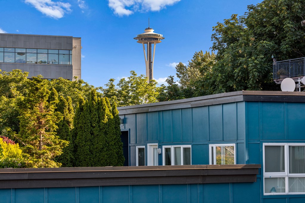 a blue building with a view of the space needle in the background  at Dexter Lake Union, Seattle, Washington
