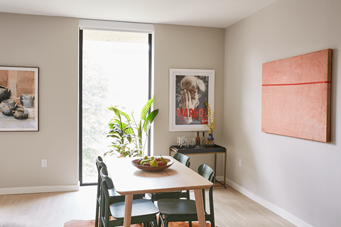 a dining room with a table and chairs and a window