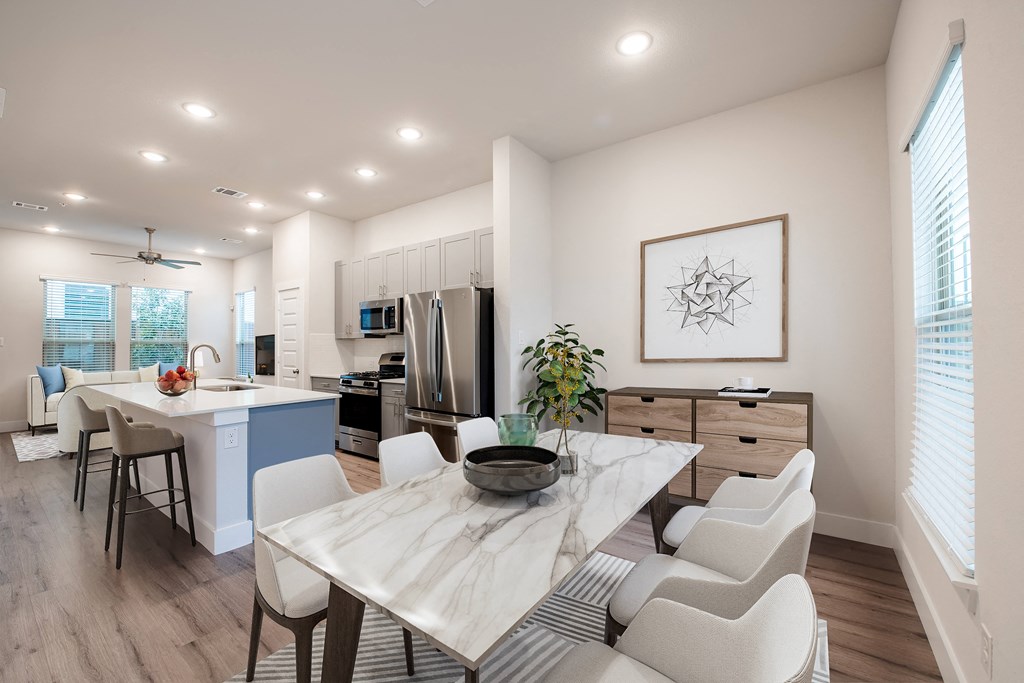 an open kitchen and dining room with a table and chairs