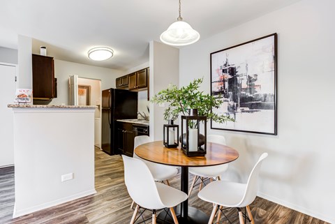 A modern kitchen with a dining table and chairs.
