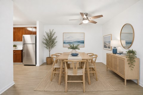 A dining room with a wooden table and chairs.