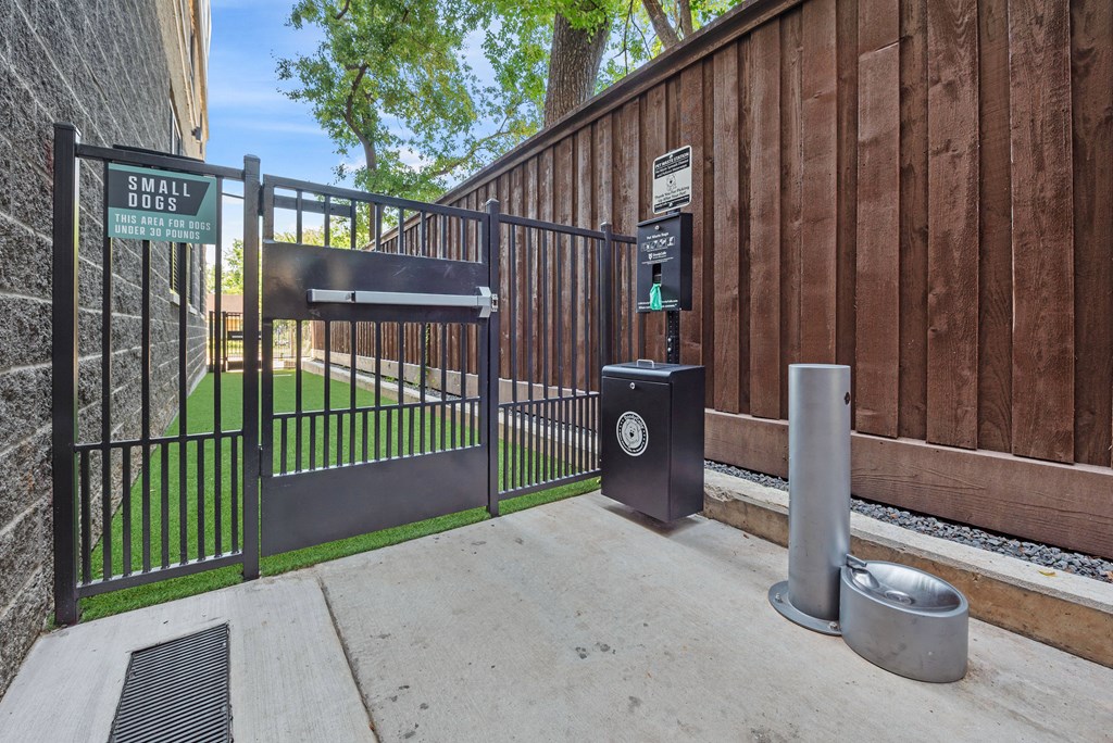 A black gate with a sign that says Small Goods is closed.