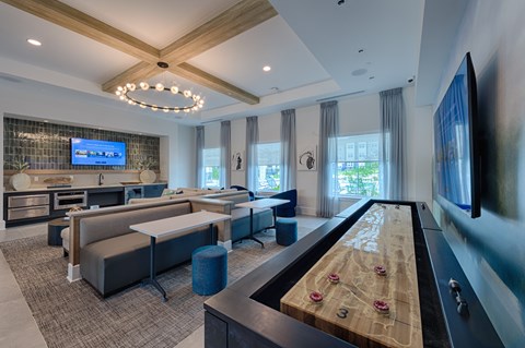 A billiard table is in the middle of a well-furnished room.
