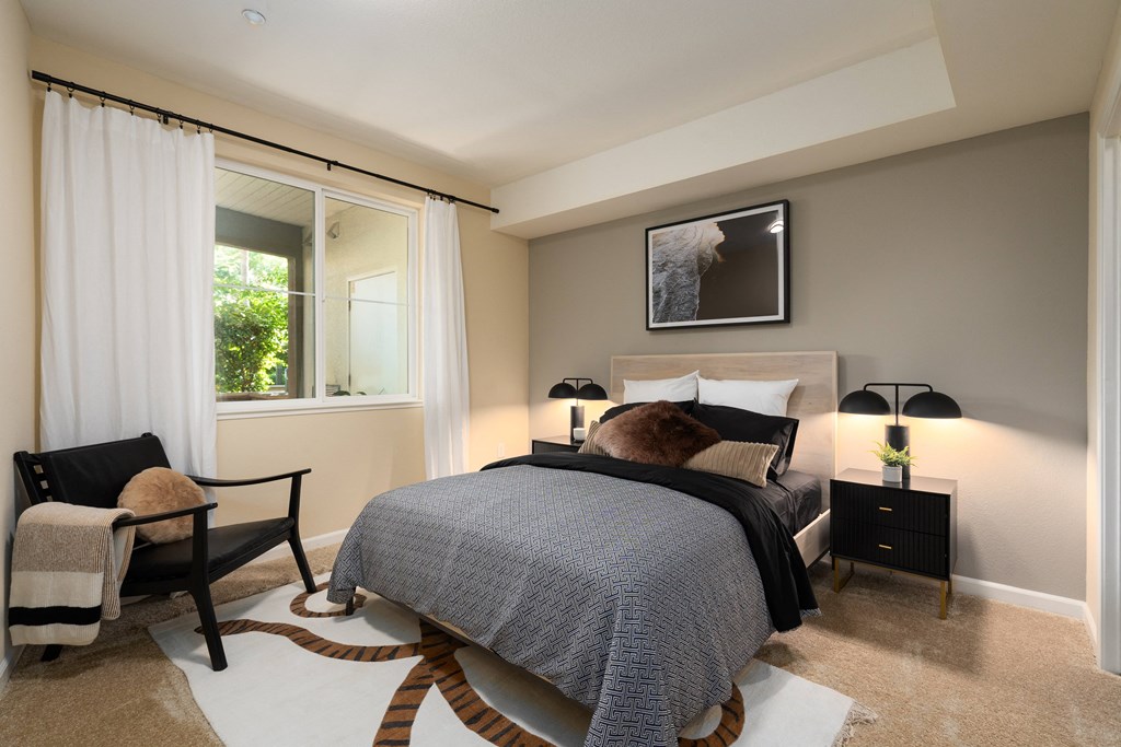 a bedroom with a bed and a window