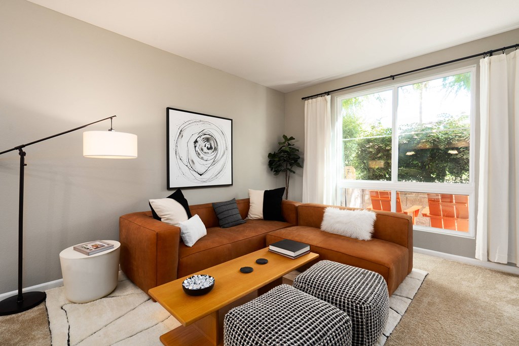 a living room with a brown couch and a coffee table