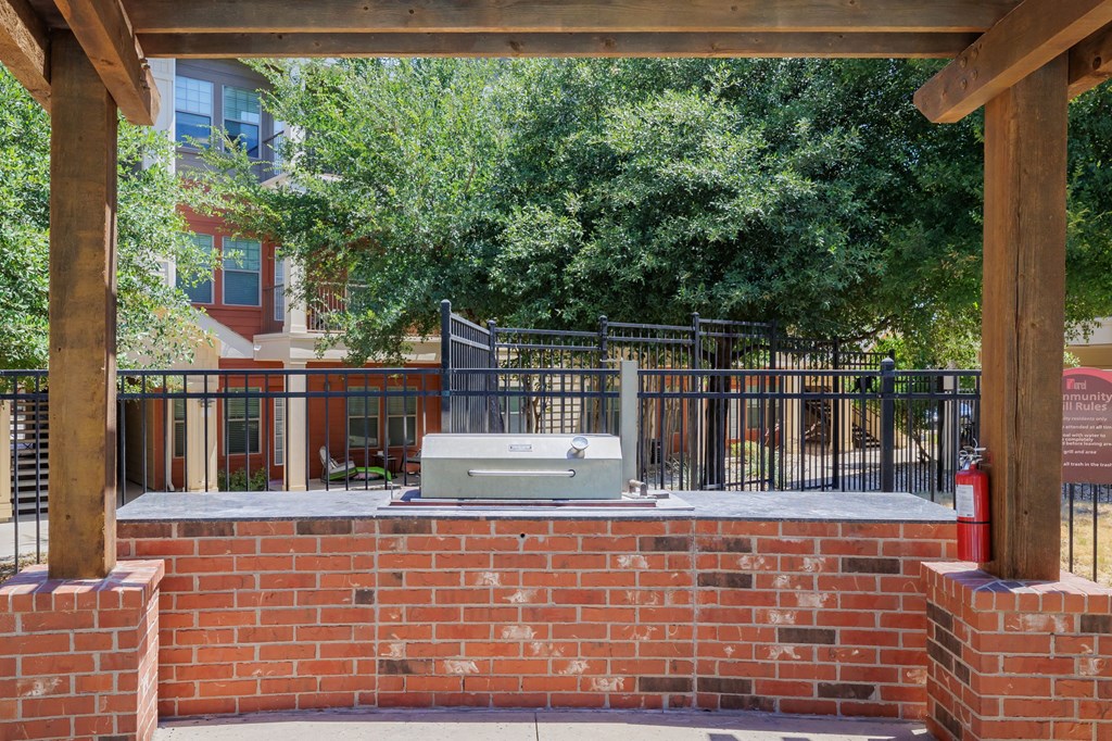 a brick wall with a grill on top of it