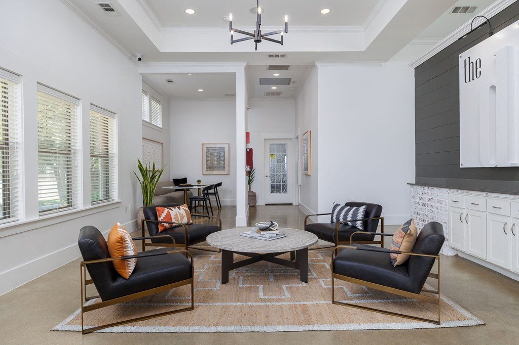 a living room with white walls and a coffered ceiling