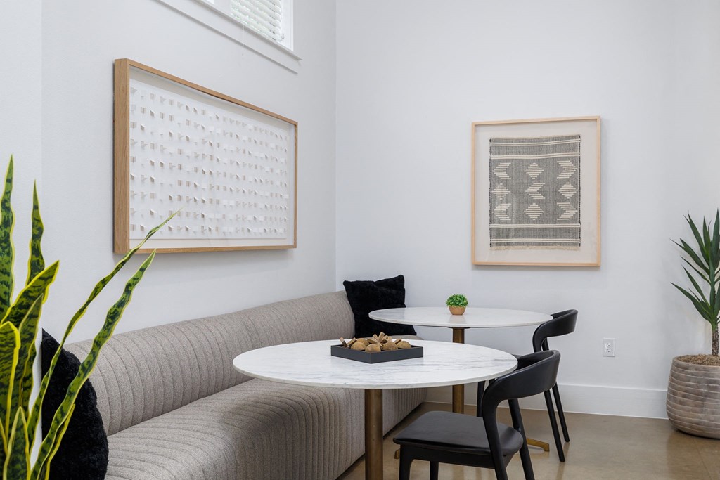 a seating area with a sofa table and two chairs